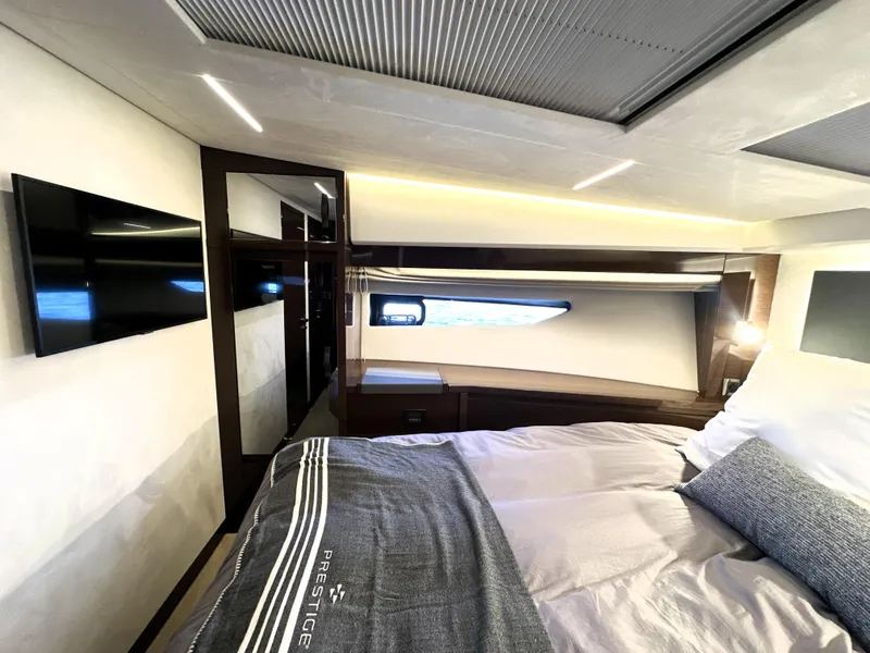Slide: The Image of Luxurious bedroom interior of 2022 Prestige 520 yacht with modern design and cozy bedding. - 43