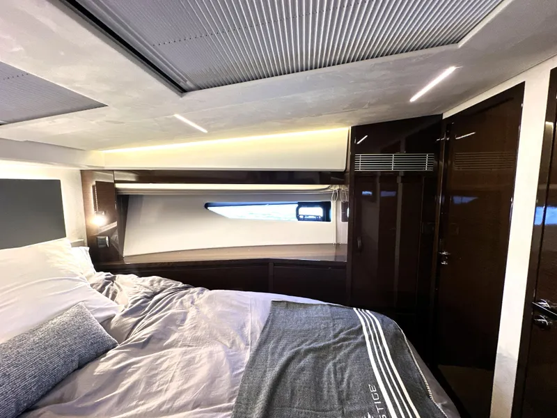 Slide: The Image of Luxurious interior of 2022 Prestige 520 yacht bedroom with modern design and cozy bedding. - 44