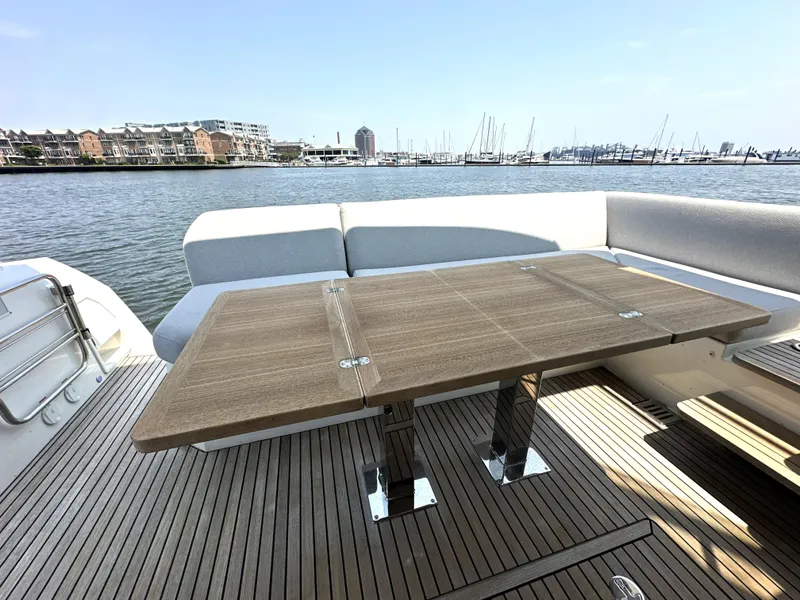Slide: The Image of Prestige 520 yacht deck with wooden table, overlooking marina, 2022 model. - 8