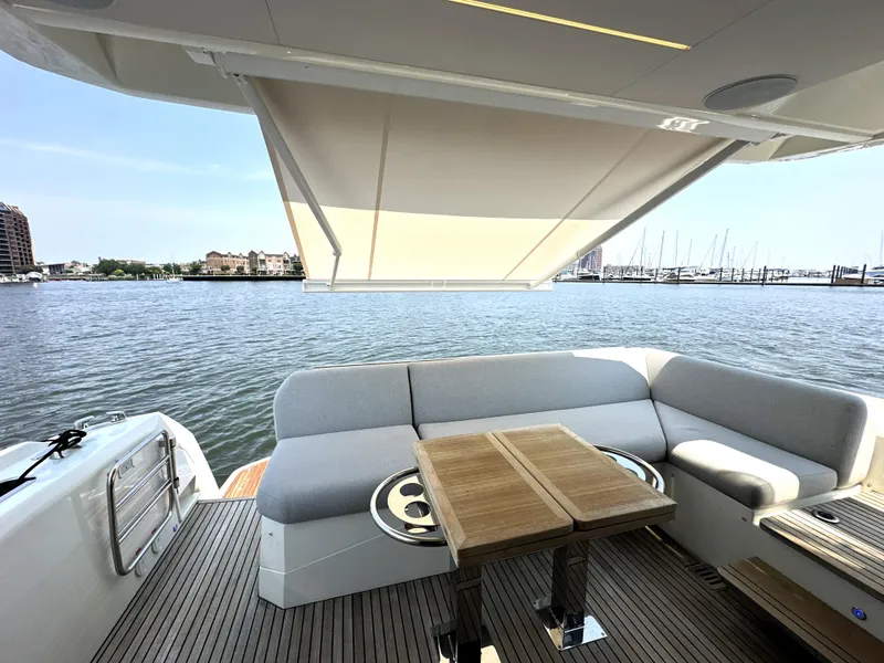 Slide: The Image of Luxury yacht deck with seating and table, Prestige 520, 2022 model, overlooking marina. - 9