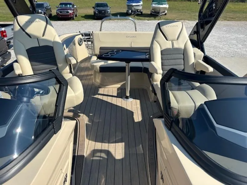 Slide: The Image of 2025 Sylvan G-3 CLZ DC boat interior with beige seating and wooden deck. - 13