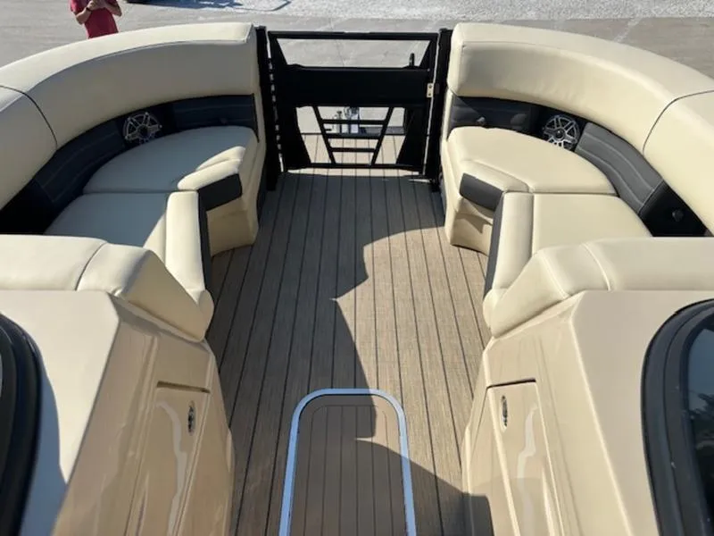Slide: The Image of Luxurious 2025 Sylvan G-3 CLZ DC boat interior with beige seating and wood flooring. - 15