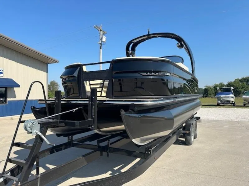 Slide: The Image of 2025 Sylvan G-3 CLZ DC pontoon boat on trailer, parked outdoors. - 2