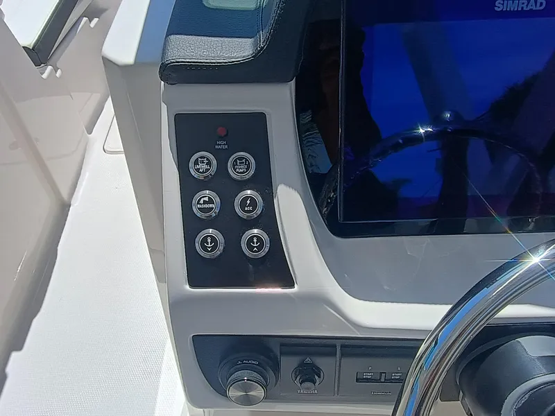 Slide: The Image of 2025 Robalo R257 Dual Console dashboard with control panel and steering wheel. - 13