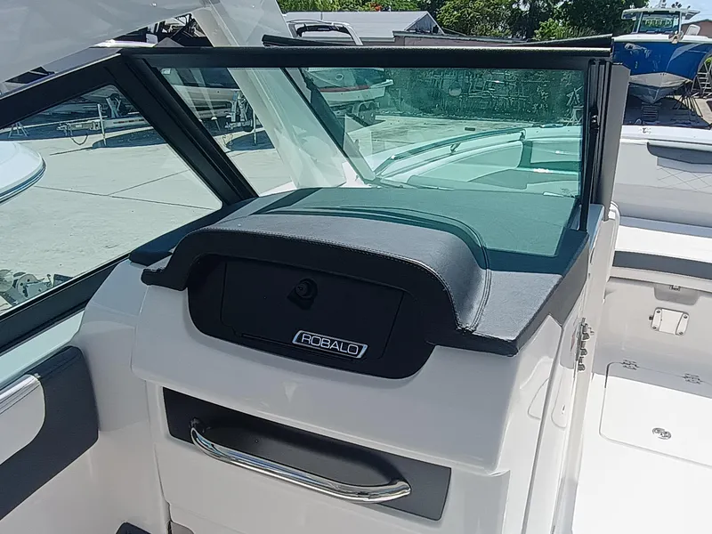 Slide: The Image of 2025 Robalo R257 Dual Console boat interior with sleek dashboard design. - 18