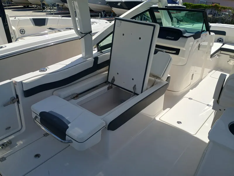 Slide: The Image of 2025 Robalo R257 Dual Console boat interior with open storage compartment. - 23