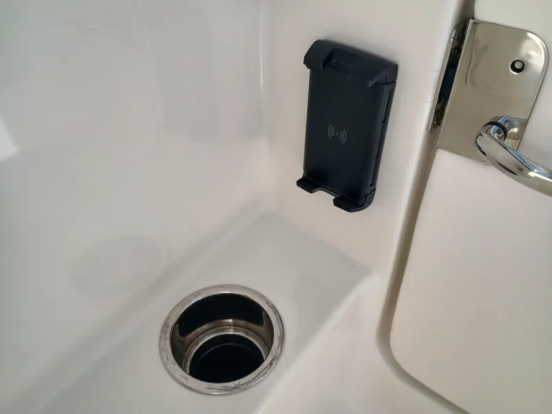 Slide: The Image of 2025 Robalo R257 Dual Console interior with cup holder and phone mount. - 42