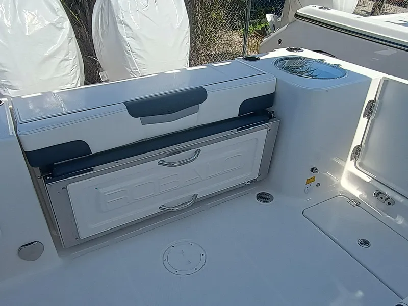 Slide: The Image of 2025 Robalo R257 Dual Console boat interior with seating and storage compartments. - 6