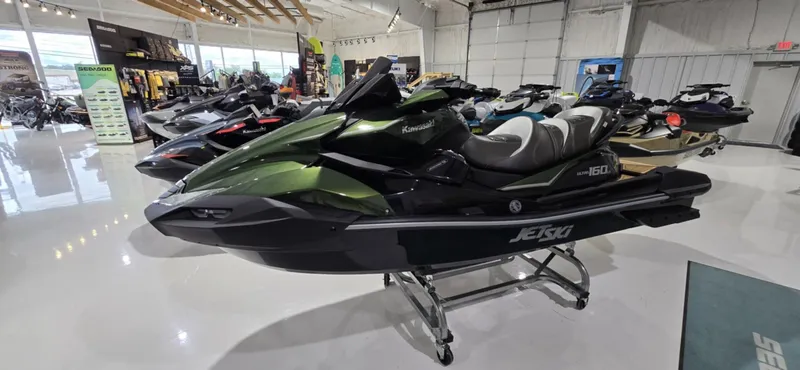 The Image of 2025 Kawasaki JetSki Ultra 160LX in showroom, sleek design, green and black color scheme. - 1