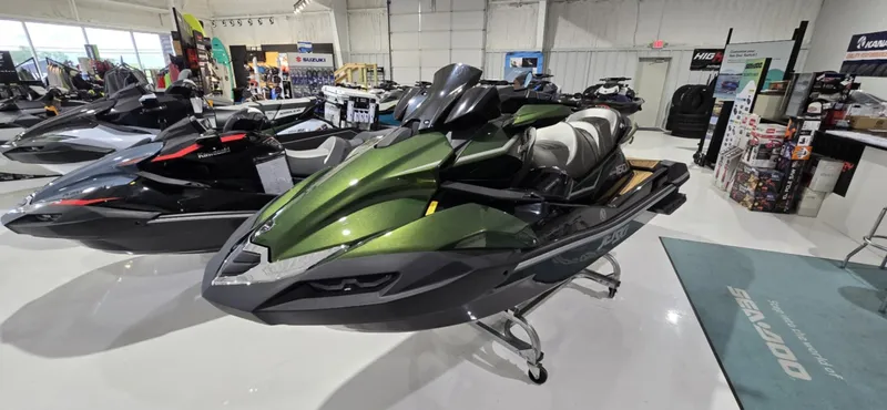 Slide: The Image of 2025 Kawasaki JetSki Ultra 160LX in showroom, sleek green design, displayed on stand. - 2