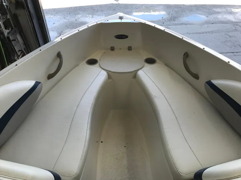 Slide: The Image of Interior view of 2012 Stingray 195 RX boat with white seating and cup holders. - 13