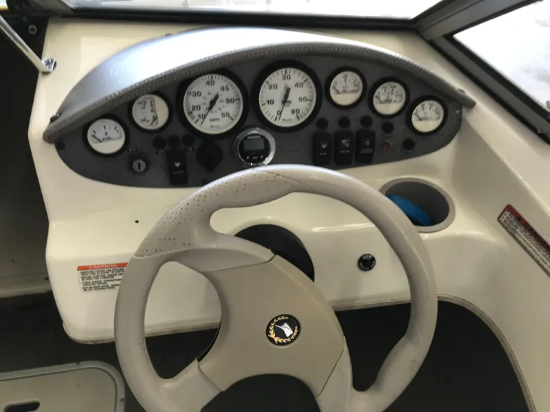 Slide: The Image of 2012 Stingray 195 RX boat dashboard with steering wheel and instrument panel. - 14