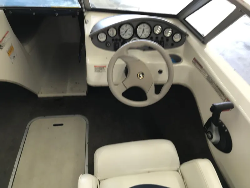Slide: The Image of Interior view of 2012 Stingray 195 RX boat cockpit with steering wheel and dashboard. - 15