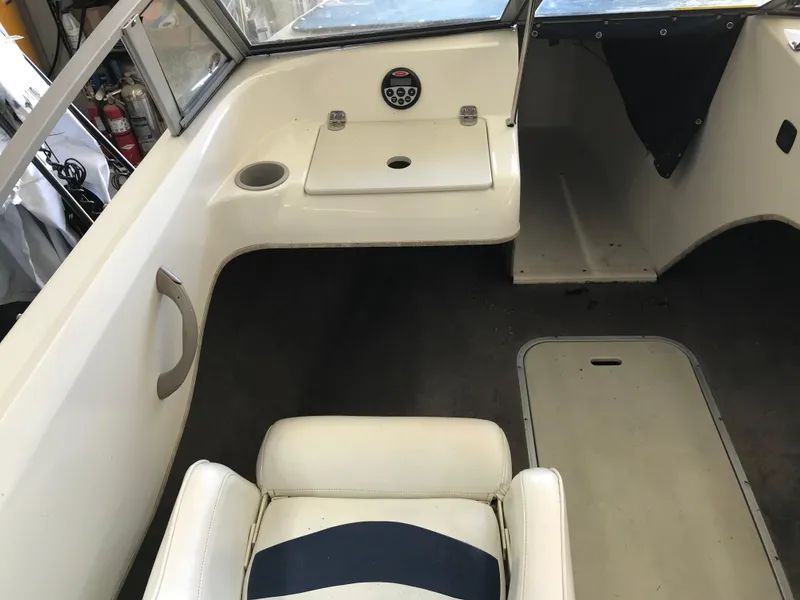 Slide: The Image of Interior of a 2012 Stingray 195 RX boat, featuring seating and dashboard controls. - 17