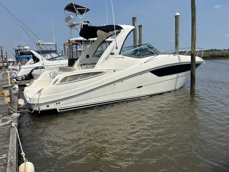 The Image of 2014 Sea Ray 330 Sundancer yacht docked at marina, side view. - 0