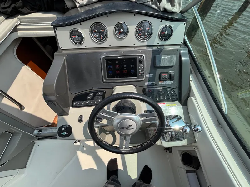 Slide: The Image of Helm of 2014 Sea Ray 330 Sundancer with steering wheel and control panel. - 12