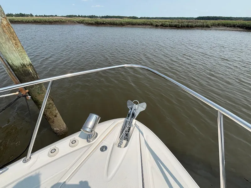 Slide: The Image of Bow of 2014 Sea Ray 330 Sundancer yacht on calm river water. - 17