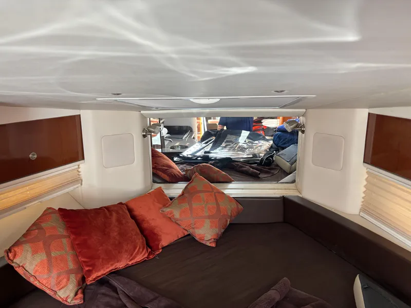 Slide: The Image of Interior cabin of 2014 Sea Ray 330 Sundancer with cozy bedding and decorative pillows. - 19