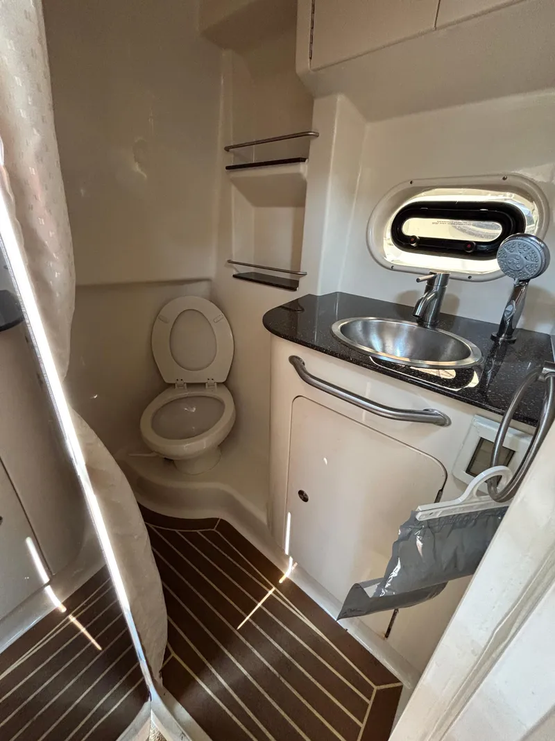 Slide: The Image of 2014 Sea Ray 330 Sundancer bathroom with sink, toilet, and wooden flooring. - 21