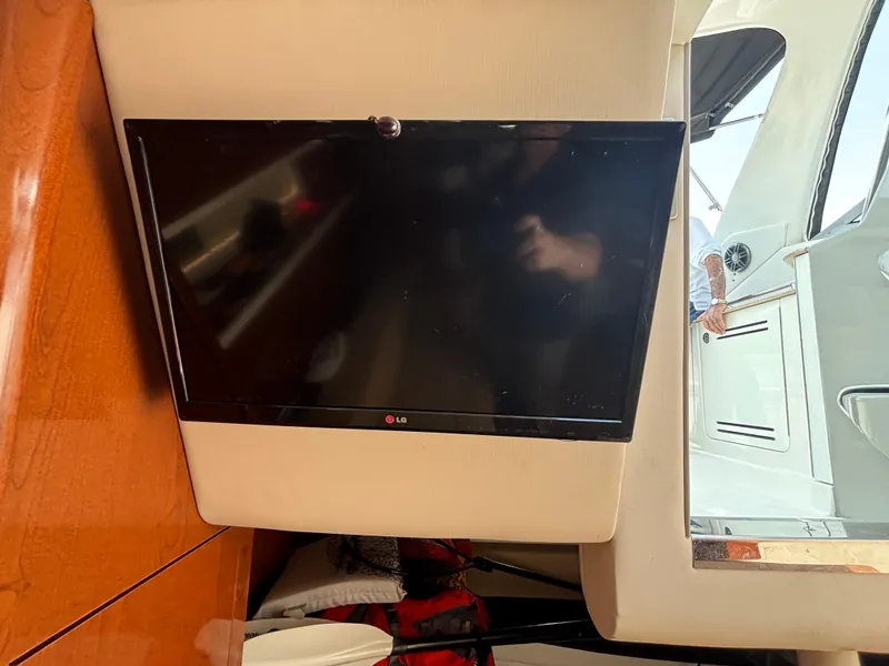 Slide: The Image of LG TV inside 2014 Sea Ray 330 Sundancer yacht, mounted on beige wall. - 24