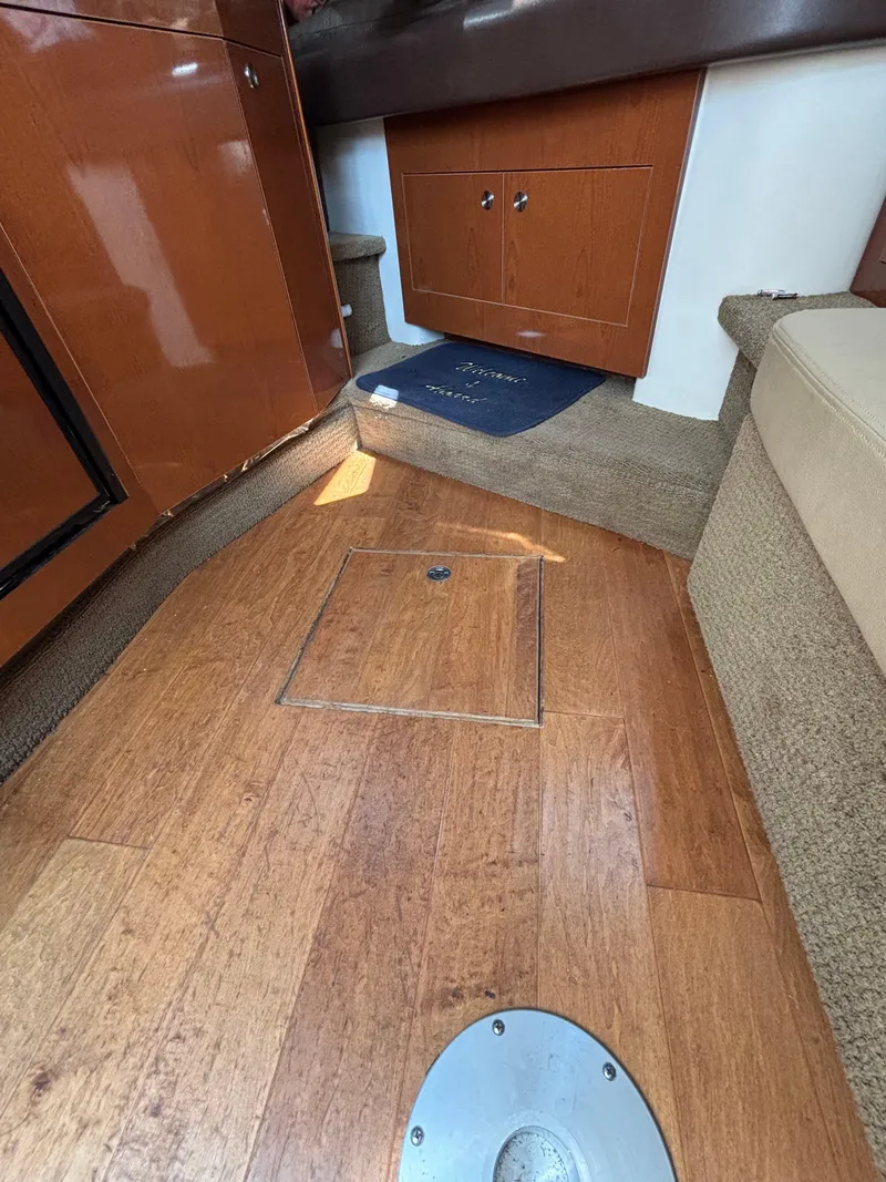 Slide: The Image of 2014 Sea Ray 330 Sundancer interior with wood flooring and cabinetry. - 27