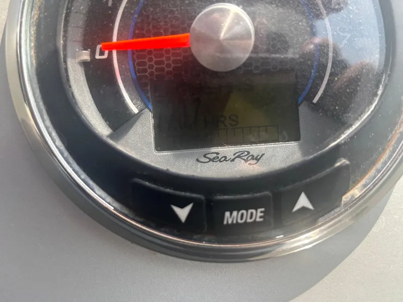 Slide: The Image of Close-up of a 2014 Sea Ray 330 Sundancer dashboard gauge with mode buttons. - 31