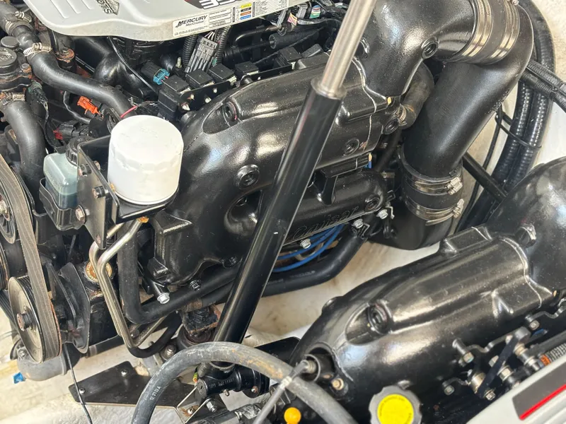 Slide: The Image of Engine compartment of a 2014 Sea Ray 330 Sundancer boat, showcasing mechanical components. - 4
