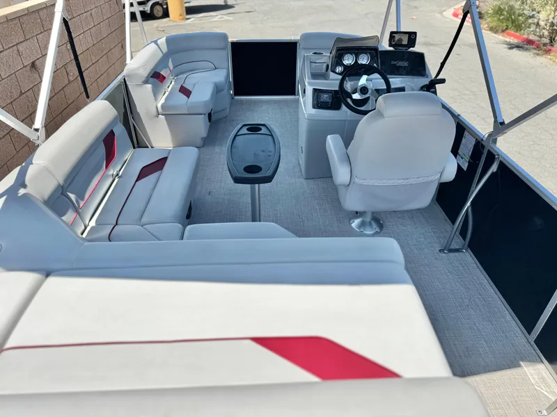 Slide: The Image of 2021 SunCatcher Select 18C pontoon boat interior with seating and steering console. - 18