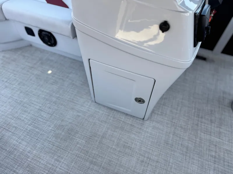 Slide: The Image of 2021 SunCatcher Select 18C boat interior with storage compartment and speaker. - 23