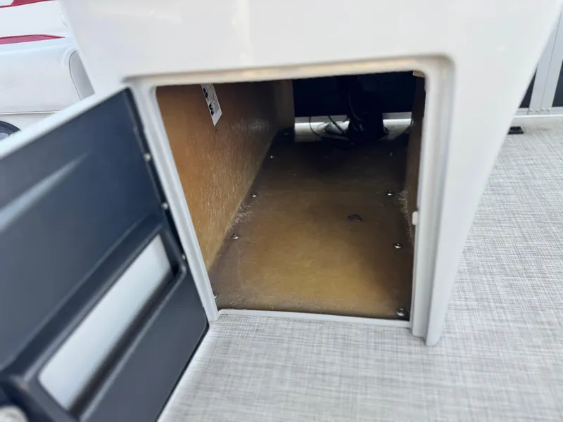 Slide: The Image of Open storage compartment in 2021 SunCatcher Select 18C boat. - 24
