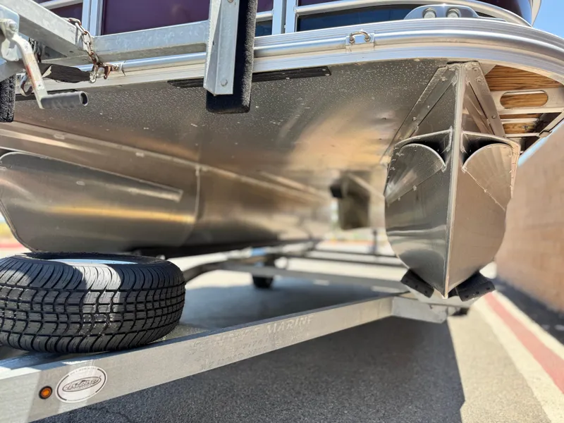 Slide: The Image of Underneath view of a 2021 SunCatcher Select 18C pontoon boat on a trailer. - 4