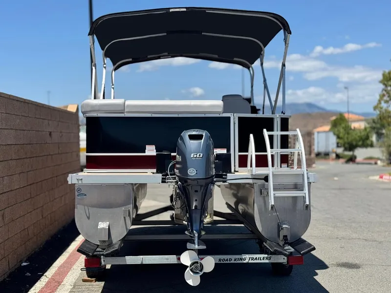 Slide: The Image of 2021 SunCatcher Select 18C pontoon boat on trailer, rear view with outboard motor. - 5