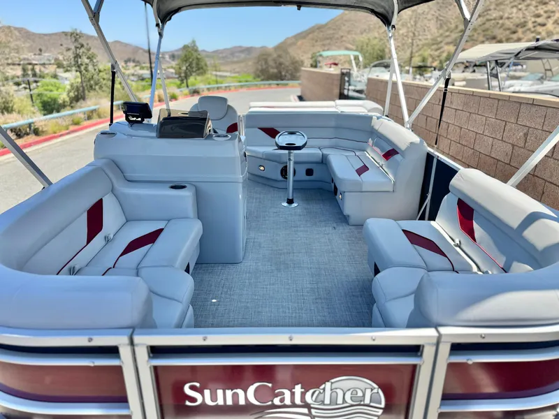 Slide: The Image of 2021 SunCatcher Select 18C pontoon boat with spacious seating and scenic background. - 8
