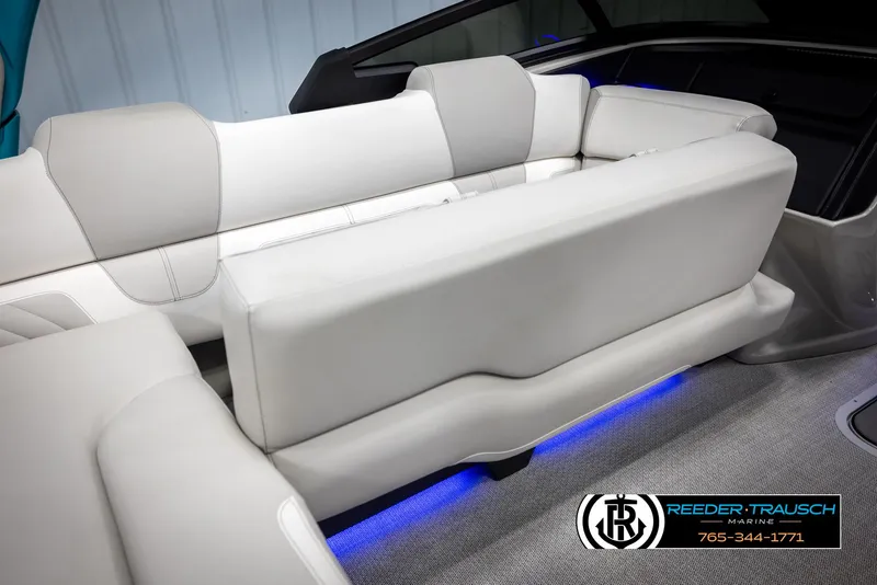 Slide: The Image of Luxurious seating in the 2025 Avalon 2585 Excal VRBW boat with ambient blue lighting. - 26
