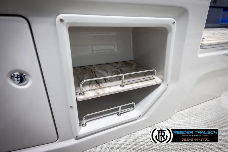 Slide: The Image of Storage compartment in 2025 Avalon 2585 Excal VRBW boat with marble-like shelves. - 33