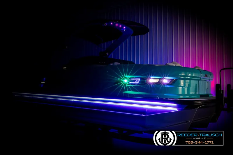 Slide: The Image of 2025 Avalon 2585 Excal VRBW pontoon boat with vibrant LED lighting in a dark setting. - 4