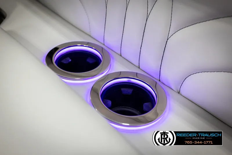 Slide: The Image of Illuminated cup holders in Avalon 2585 Excal VRBW boat, 2025 model, with sleek white upholstery. - 48
