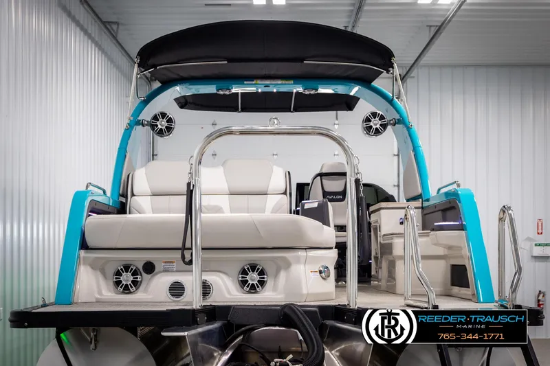 Slide: The Image of 2025 Avalon 2585 Excal VRBW pontoon boat in showroom, featuring sleek design and modern seating. - 7
