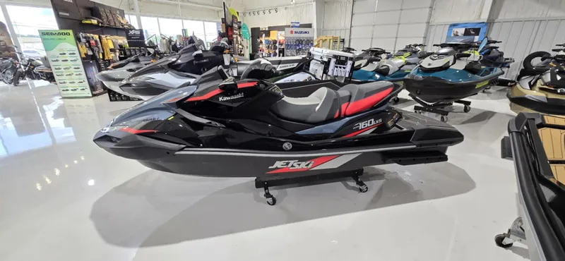The Image of 2025 Kawasaki Jetski Ultra 160 LX-S displayed in showroom, sleek black and red design. - 1