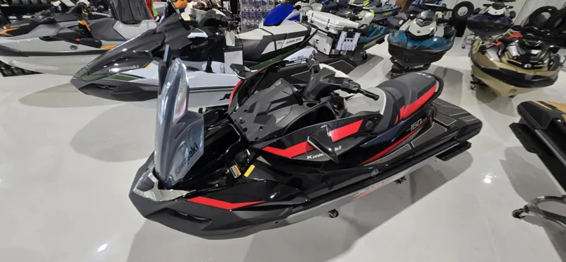 Slide: The Image of 2025 Kawasaki Jetski Ultra 160 LX-S in showroom, sleek black and red design. - 3