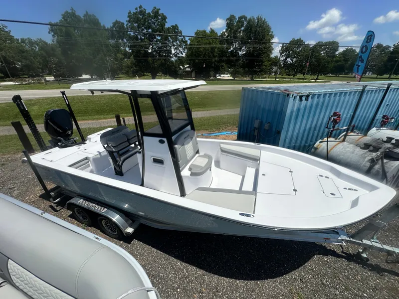 Slide: The Image of 2026 Action Craft 24 Bay boat on trailer, parked outdoors under clear sky. - 10