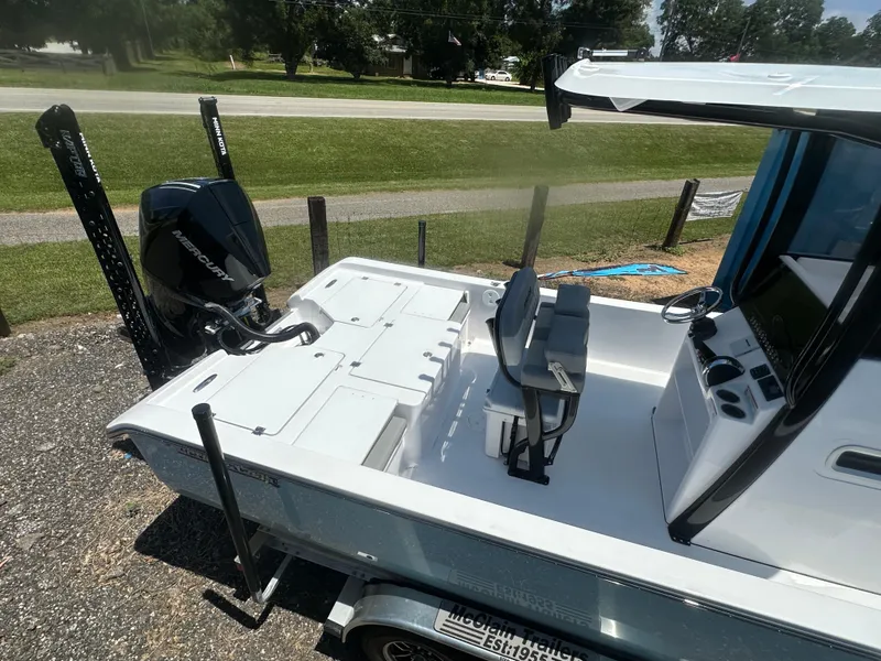 Slide: The Image of 2026 Action Craft 24 Bay boat with Mercury engine, featuring a sleek interior design. - 11