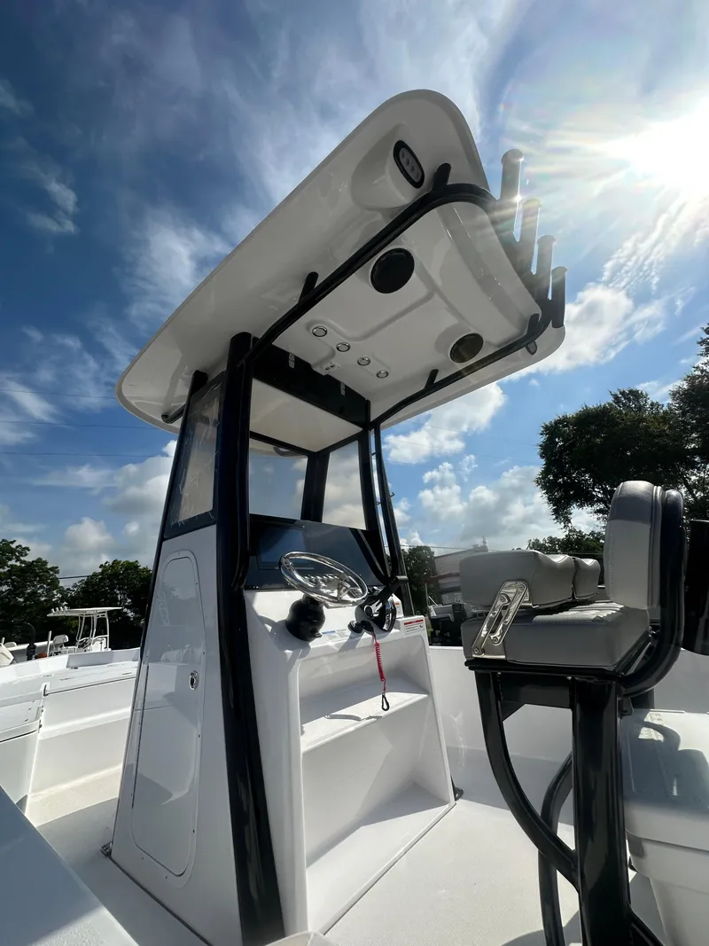 Slide: The Image of 2026 Action Craft 24 Bay boat console under sunny sky. - 19