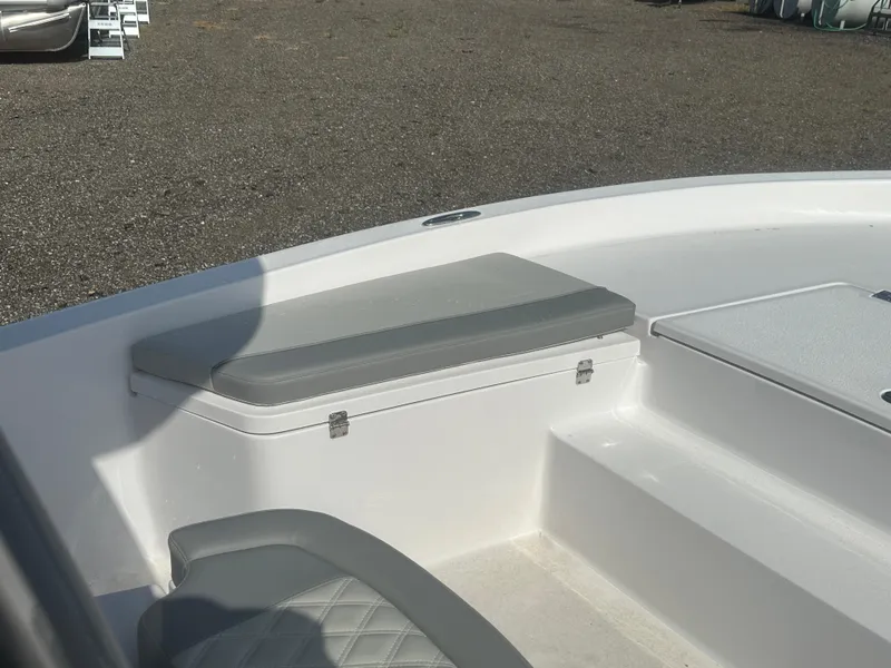 Slide: The Image of 2026 Action Craft 24 Bay boat interior with cushioned seating and storage compartment. - 28