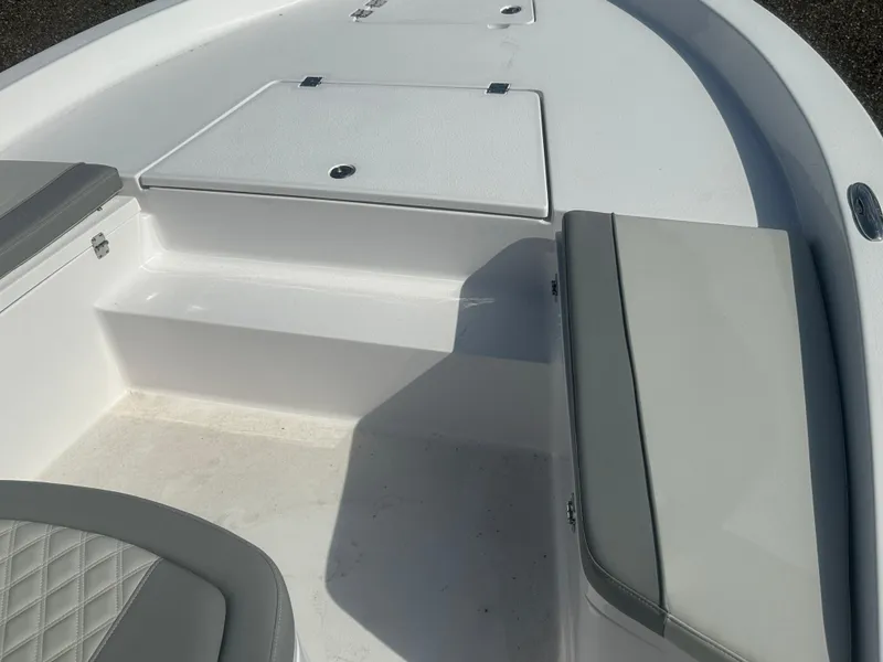 Slide: The Image of 2026 Action Craft 24 Bay boat interior with cushioned seating and storage compartments. - 29