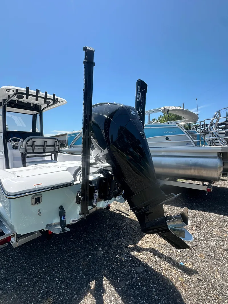 Slide: The Image of 2026 Action Craft 24 Bay boat with powerful outboard motor in a sunny marina. - 6