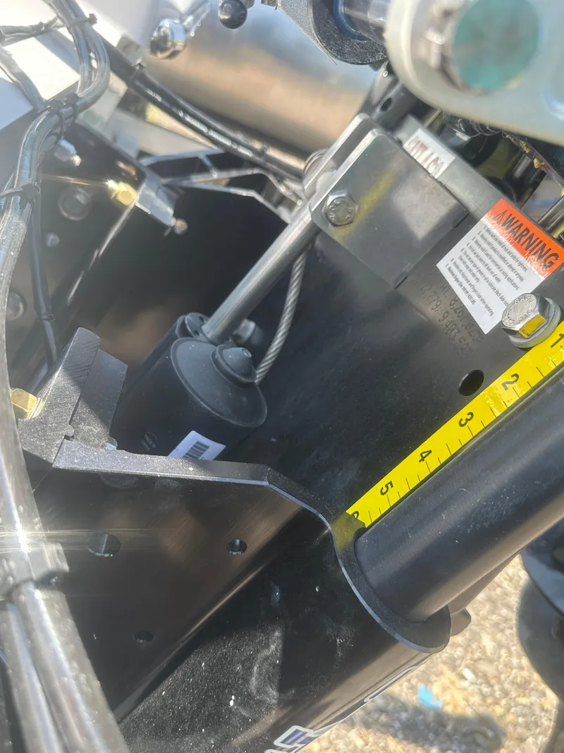 Slide: The Image of Close-up of 2026 Action Craft 24 Bay boat engine components and measurement markings. - 14