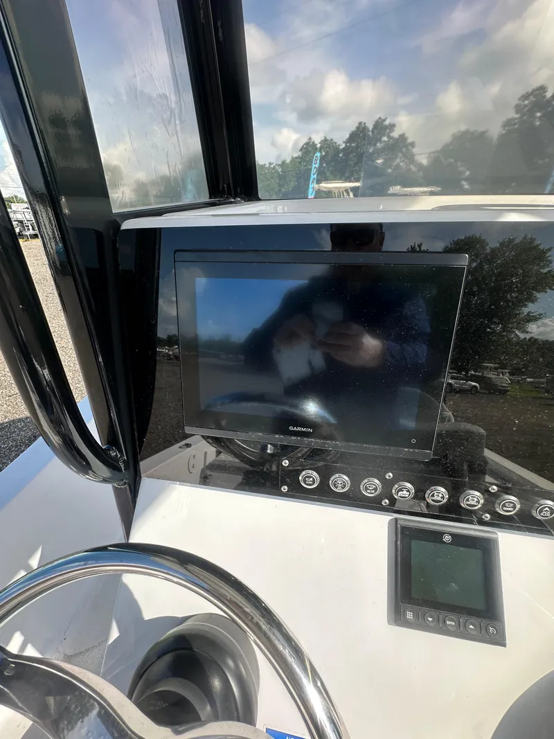 Slide: The Image of 2026 Action Craft 24 Bay boat dashboard with Garmin display and steering wheel. - 20