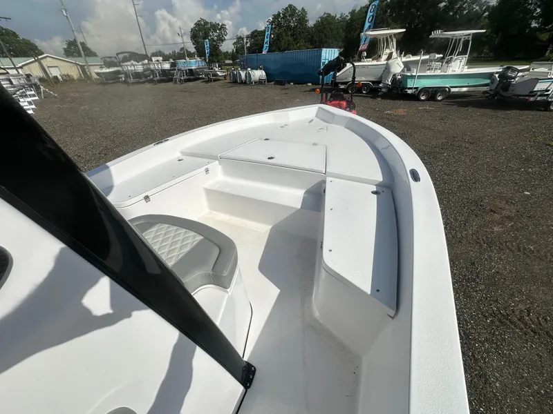 Slide: The Image of 2026 Action Craft 24 Bay boat deck with seating, displayed outdoors. - 23