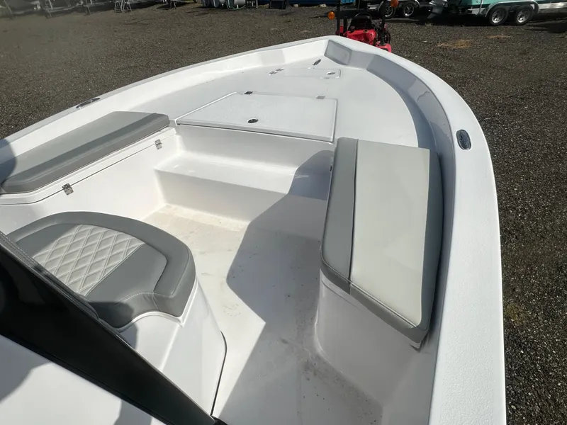 Slide: The Image of 2026 Action Craft 24 Bay boat interior with cushioned seating and storage compartments. - 27